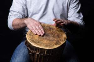Man playing african djembe drum